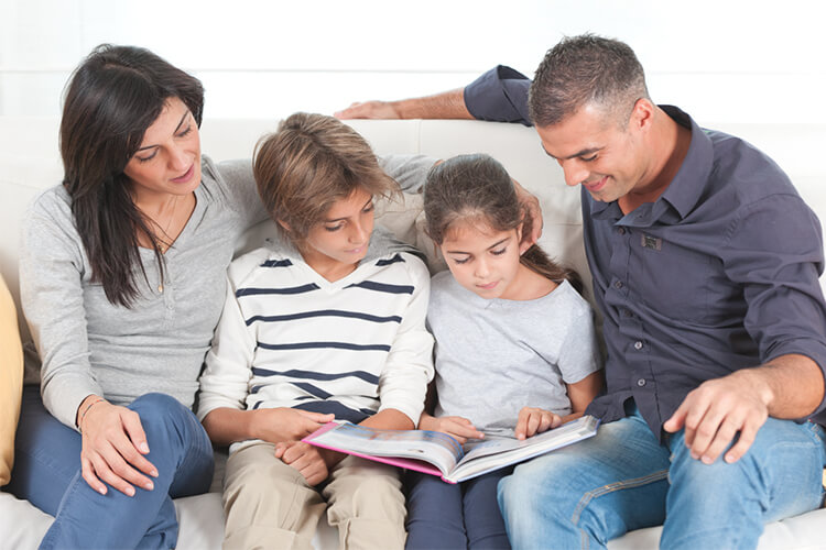 Family reading together on couch